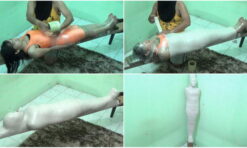 [RM099] A girl in an orange swimsuit is mummified on wood and breathplay