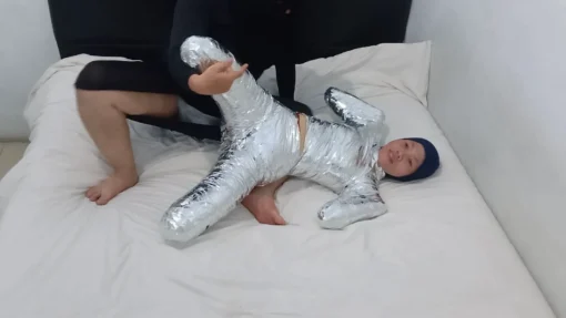 [RM161] This Girl Is Wrapped Tightly In Frogtied Position Like A Helpless Pet Wrapped In Duct Tape