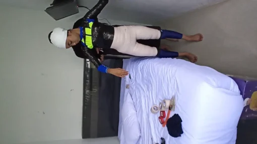 [RM159] A beautiful girl is wrapped into a mummy with white duct tape with both hands wrapped together in front - Image 2